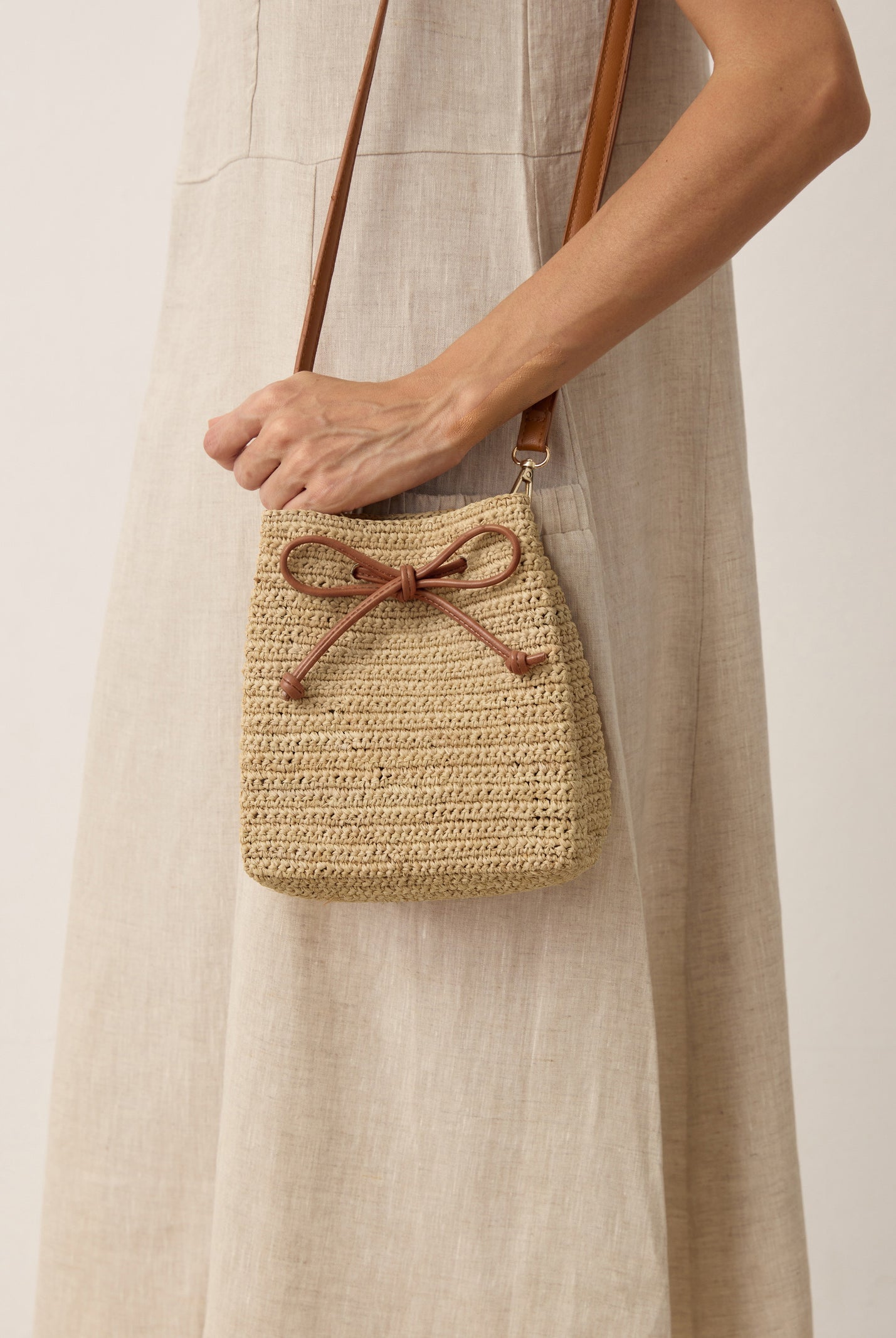 Mini Handwoven Raffia Drawstring Crossbody Bag by LINTICO for women