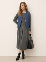 Model wearing a charcoal grey wool pleated midi dress with an indigo linen vest