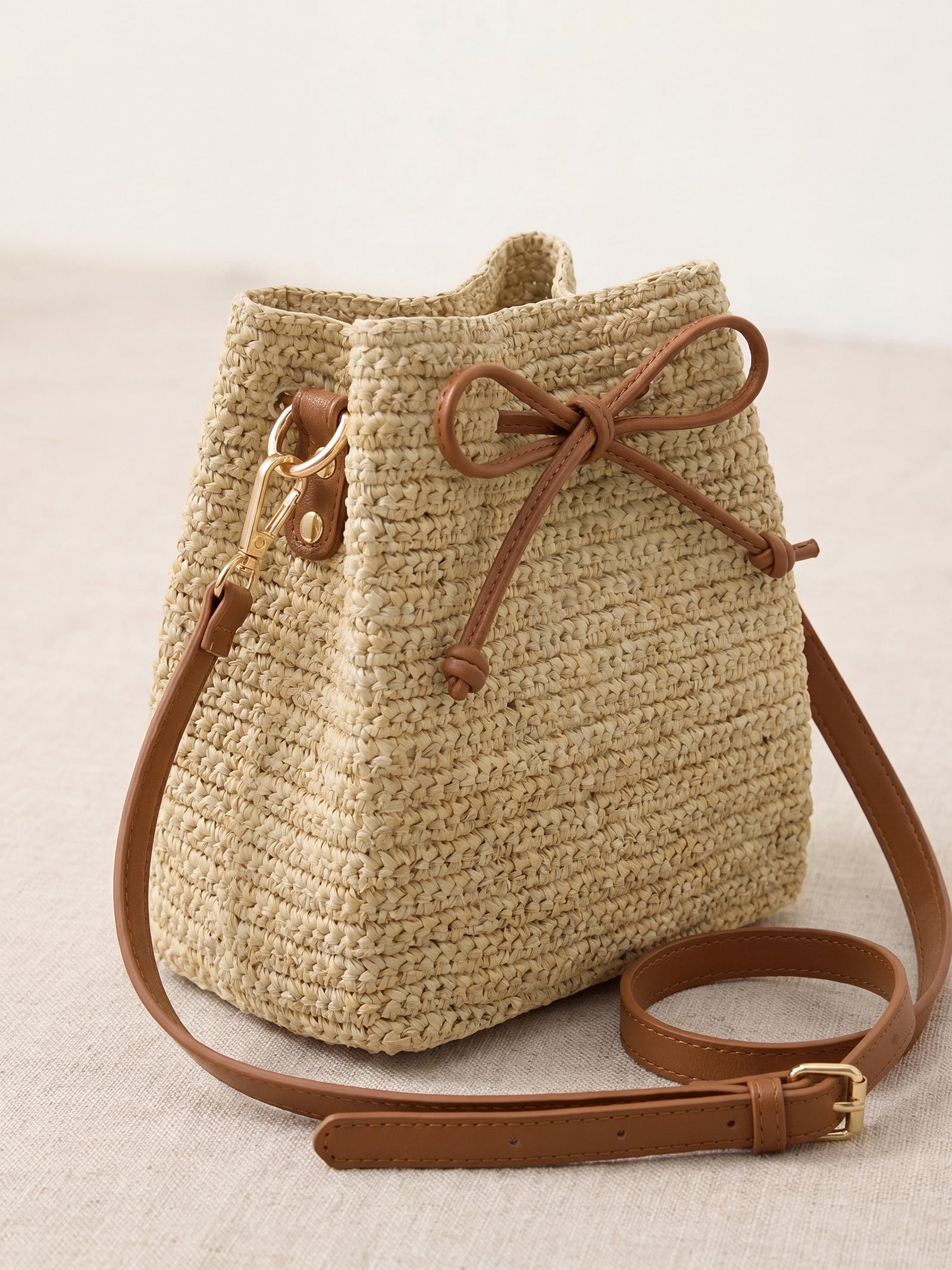 Mini Handwoven Raffia Drawstring Crossbody Bag by LINTICO for women