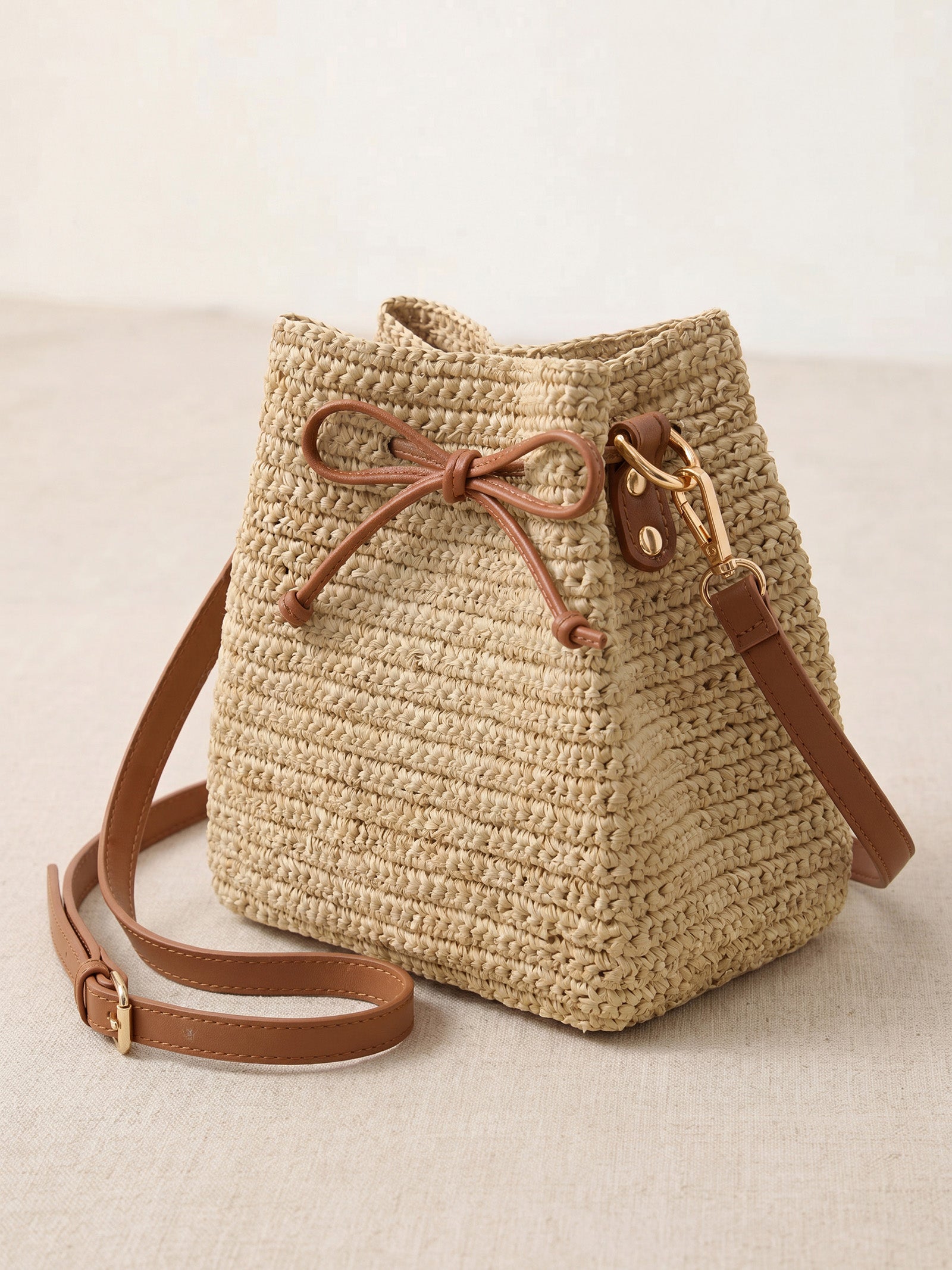 Mini Handwoven Raffia Drawstring Crossbody Bag by LINTICO for women