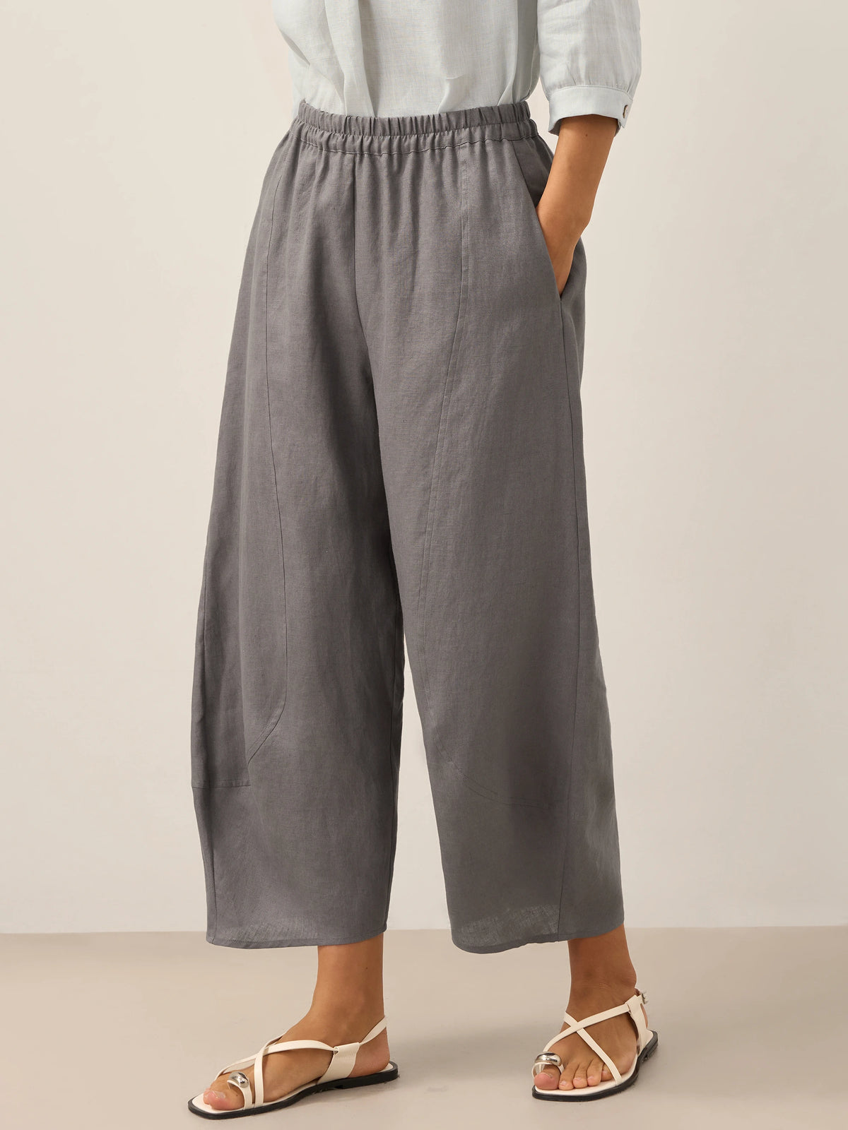ZOE neutral grey linen ankle pants in an outdoor lifestyle image