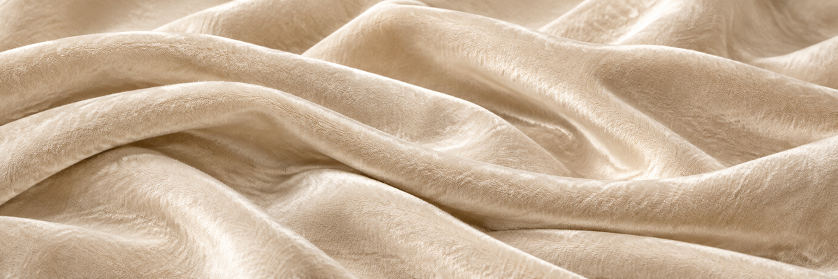 Silk velvet garment with a fluid drape in warm light