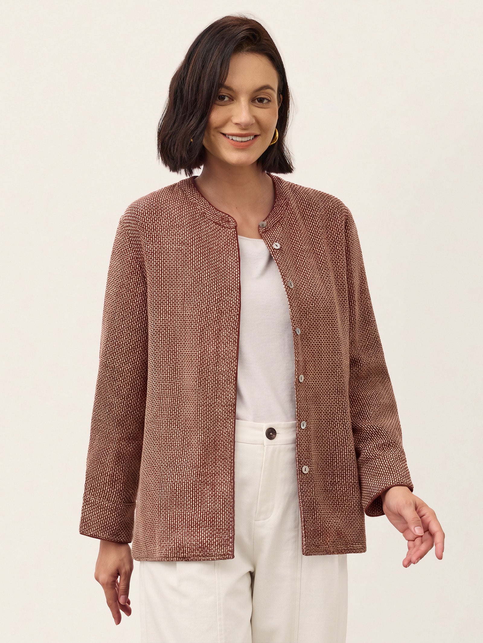 Model wearing a Merlot Red check long sleeve shirt with white trousers